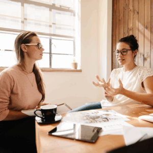 Two women in business converse