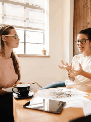 Two women in business converse